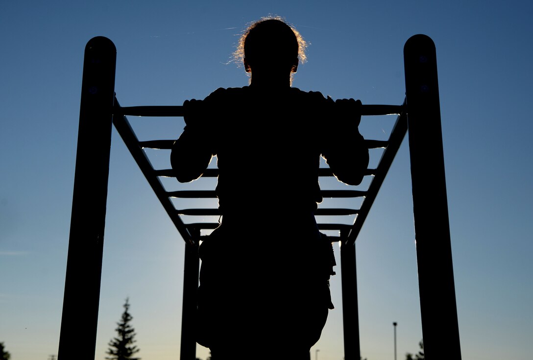 U.S. Air Force Airman 1st Class Alexandranell Soto, a 354th Security Force Squadron response force leader completes a pull-up during a special weapons and tactics (SWAT) physical training test June 23, 2021 on Eielson Air Force Base, Alaska. The defenders conducted multiple exercises to ensure they are physically fit and capable of completing the SWAT training. (U.S. Air Force photo by Senior Airman Beaux Hebert)