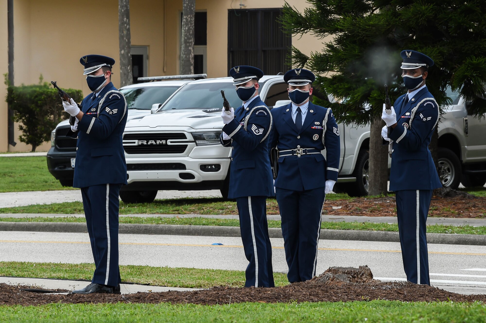 Airmen conduct a three-rifle volley salute