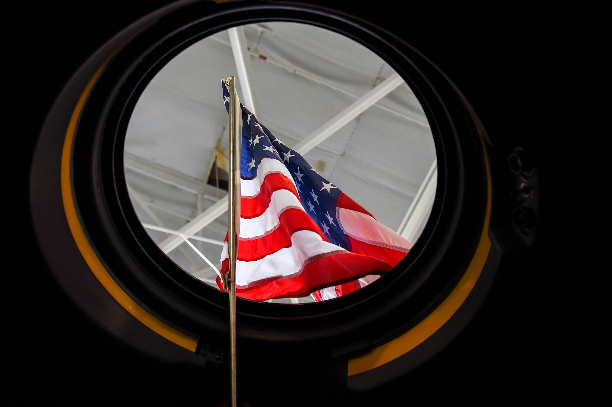 A flag is displayed out of a C-130 aircraft