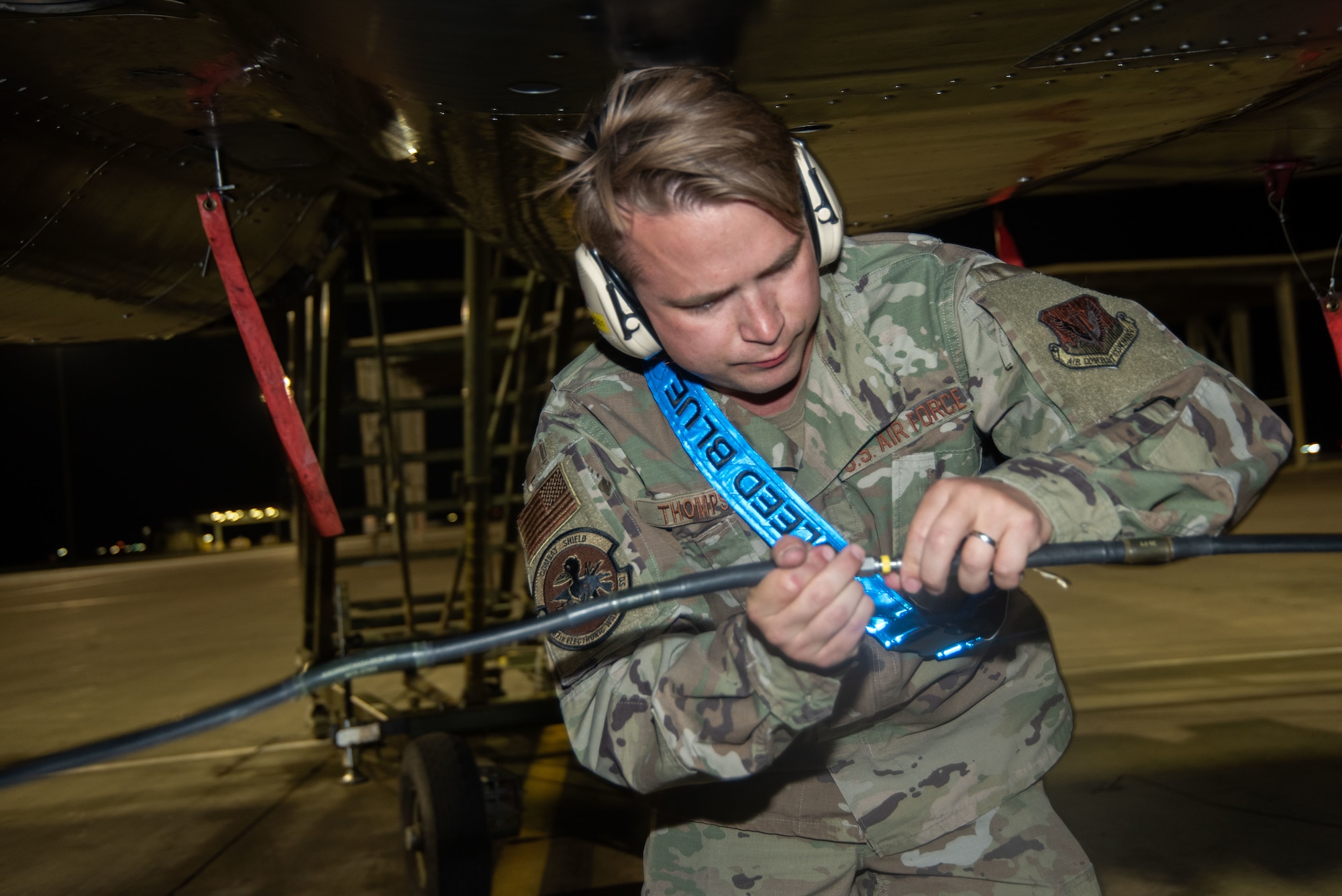 A Airman connects two cords.