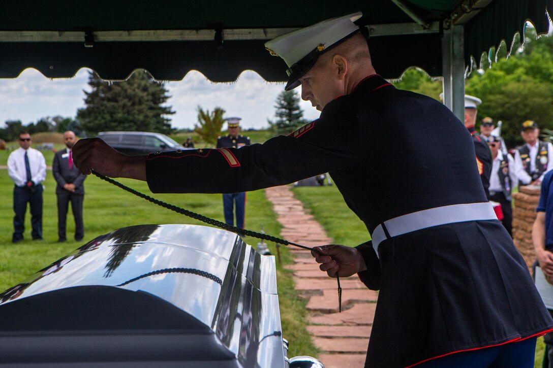 U.S. Marine Corps Sgt. Hunter Haffly, a squad leader with 1st Battalion, 6th Marine Regiment (1/6), 2d Marine Division, places a French Fourragere on the casket of U.S. Marine Corps Sgt. Donald D. Stoddard at Mountain View Memorial Park in Boulder, Colo., June 26, 2021. Stoddard died during the siege of Betio Island in November 1943 during World War II while assigned to 1/6. His remains were recovered in March 2019 by the non-profit organization, History Flight. (U.S. Marine Corps photo by Cpl. Chase W. Drayer)