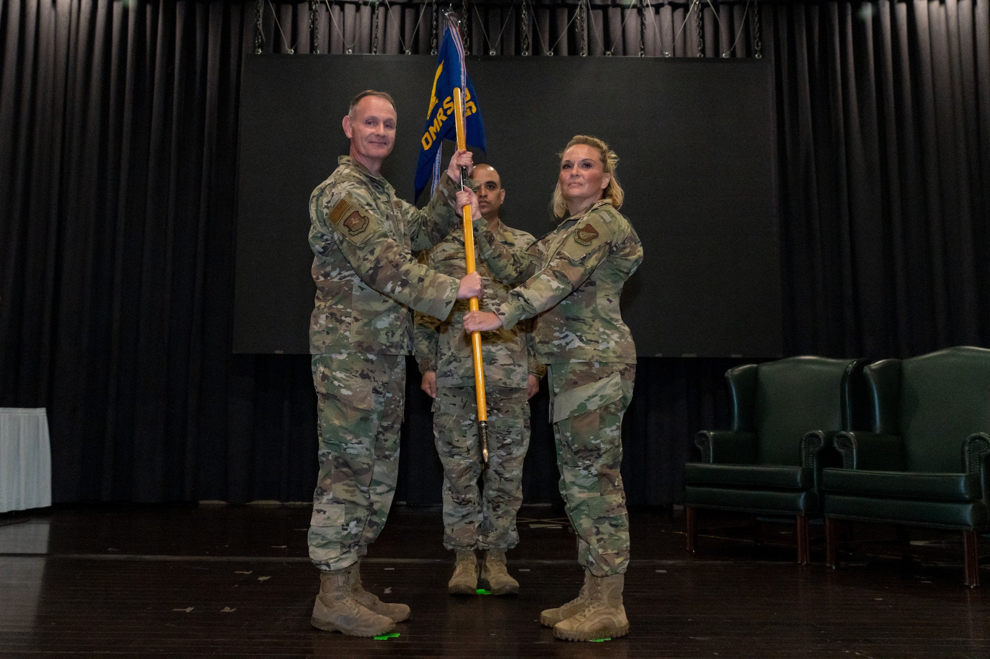 Col. Michael Fea, 51st Medical Group commander, left, passes the guidon to Lt. Col. Shannon Hunt, 51st Operational Medical Readiness Squadron commander at Osan Air Base, Republic of Korea, June 29, 2021. As the presiding officer, Fea facilitated the transition of 51 OMRS command by presenting the ceremonial guidon to the incoming officer. (U.S. Air Force photo by Tech. Sgt. Nicholas Alder)