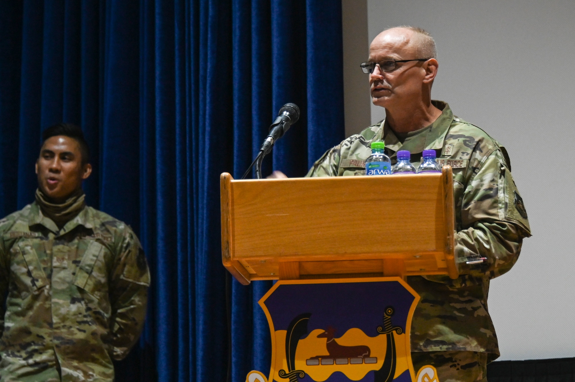 A photo of a commander speaking at a ceremony