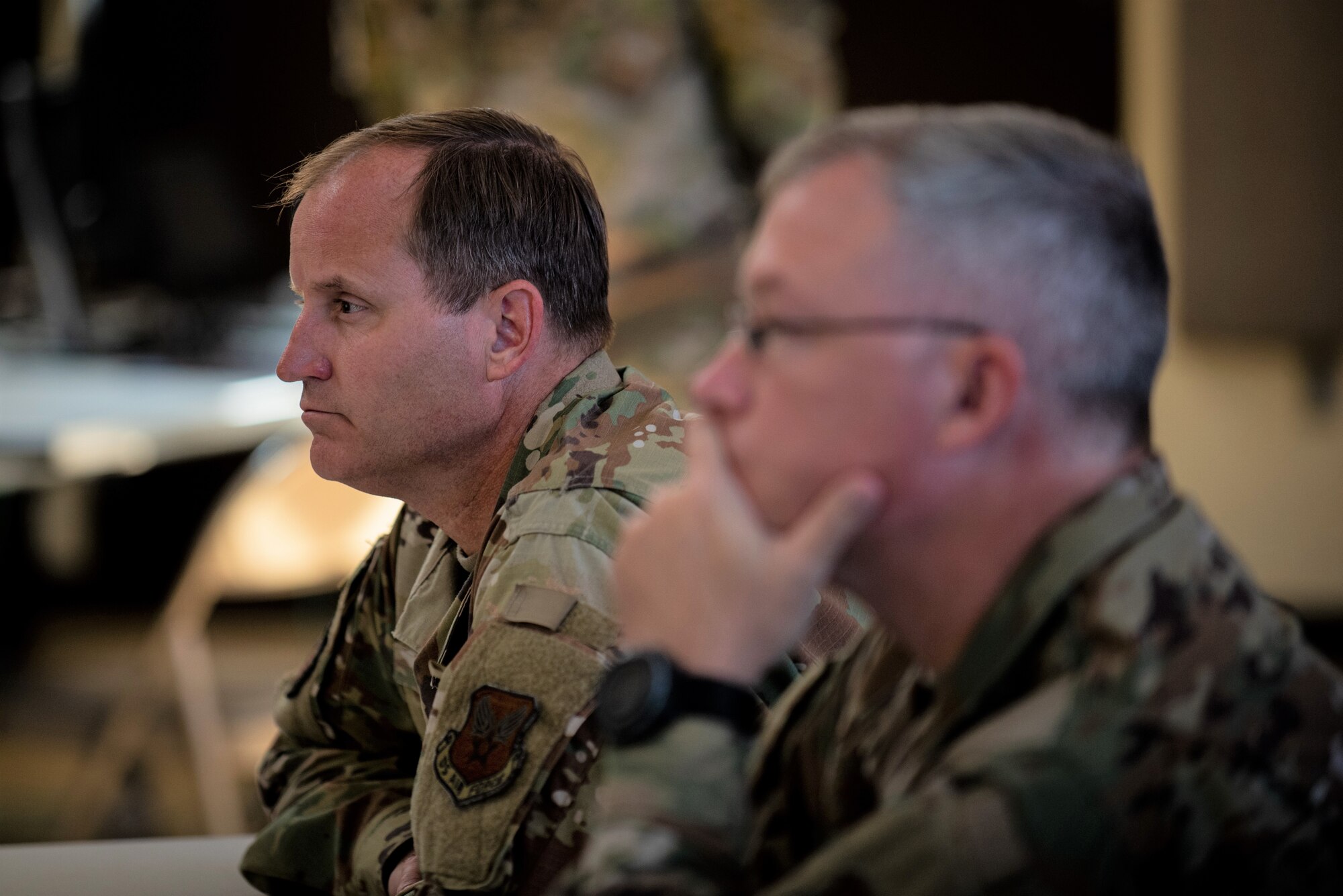 Air Force contracting leaders listen to a briefing