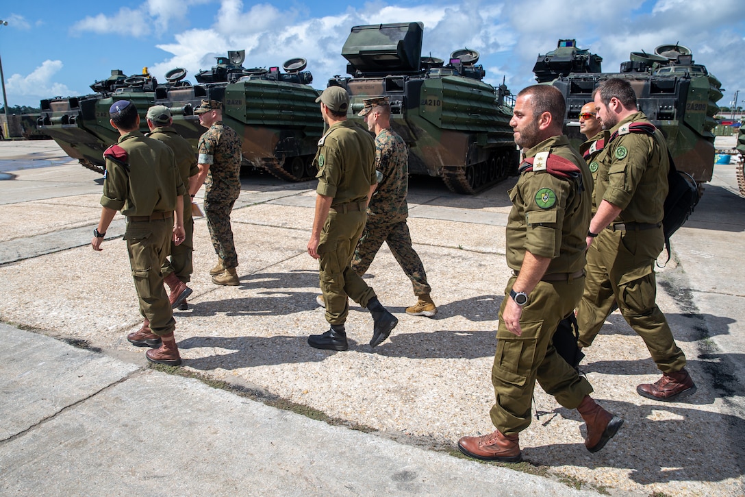 U.S. Marines with 2d Assault Amphibian Battalion (AABn.), 2d Marine Division, and Israeli Defense Forces (IDF) soldiers discuss littoral combat tactics on Camp Lejeune, N.C., June 28, 2021. IDF commanders visited 2d AABn. to learn about Marine Corps amphibious combat operations and the capabilities of the assault amphibious vehicle. (U.S. Marine Corps photo by Lance Cpl. Brian Bolin Jr.)