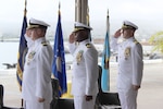 Three Navy officers salute