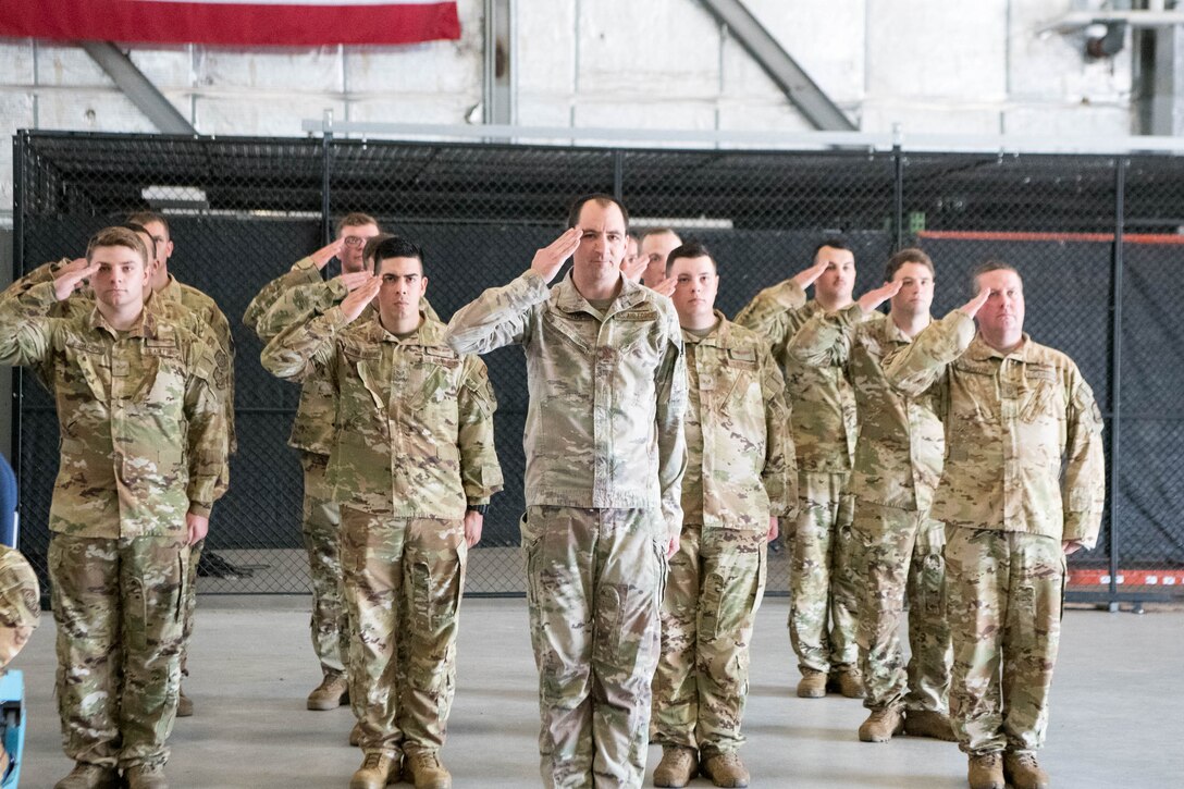 A formation of Airmen gives Lt. Col. James Shepard his first salute during the 9th Airlift Squadron change of command ceremony at Dover Air Force Base, Delaware, June 25, 2021. The ceremony saw Lt. Col. John Habbestad relinquish command to Shepard. The 9th AS routinely trains to provide global reach with unique outsized and oversized airlift capability on the C-5M Super Galaxy. (U.S. Air Force photo by Mauricio Campino)
