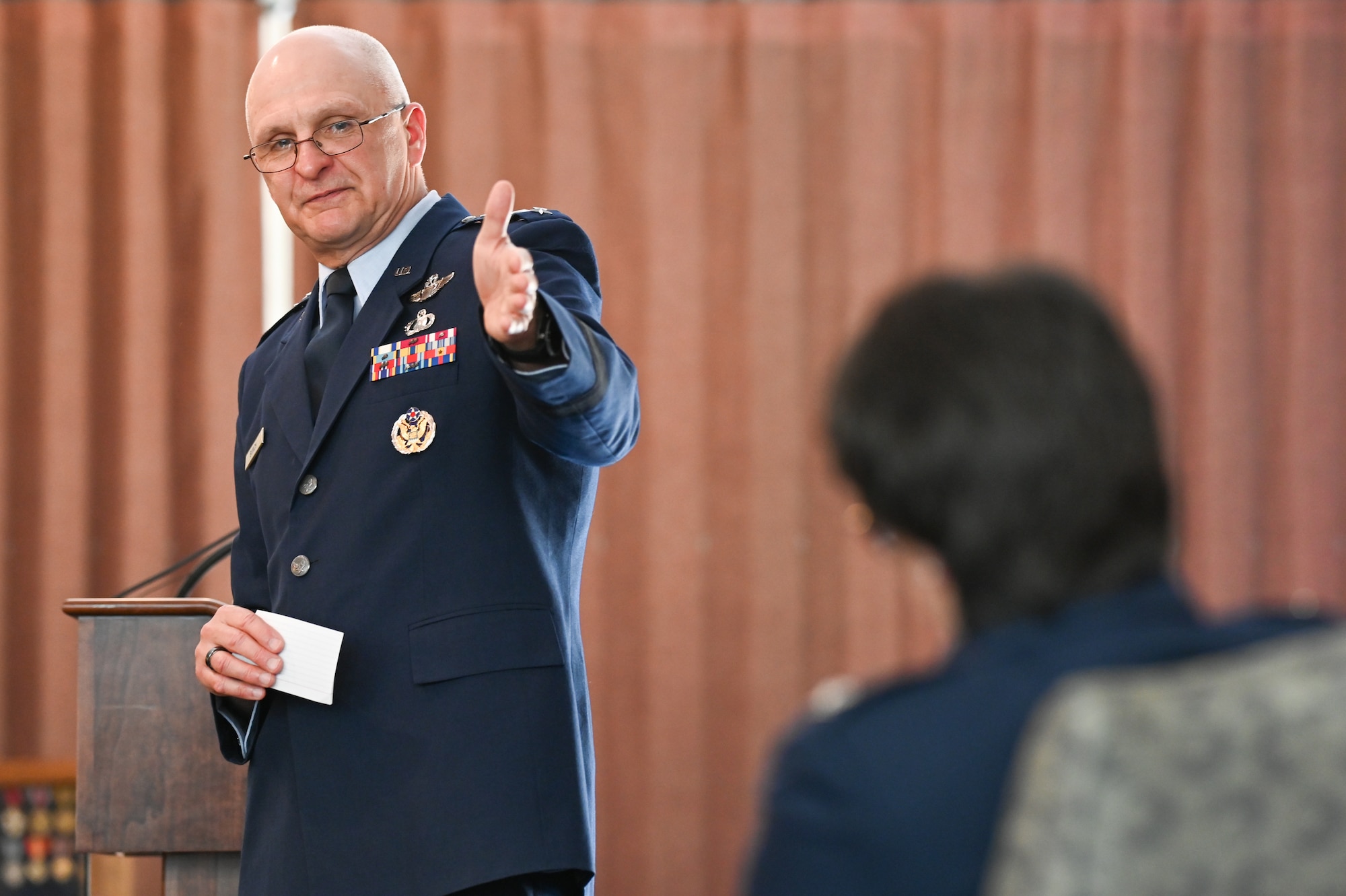 Gen. Arnold W. Bunch Jr., commander, Air Force Materiel Command, congratulates Col. Amanda G. Kato during the retirement ceremony honoring her more than 29 years of service in the Air Force on June 18, 2021, at Hanscom Air Force Base, Massachusetts. (U.S. Air Force photo by Todd Maki)