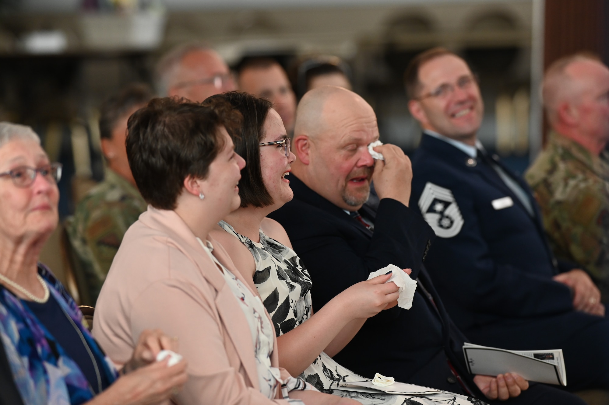 Family members of Col. Amanda G. Kato react to comments during the retirement ceremony honoring Kato’s more than 29 years of service in the Air Force on June 18, 2021, at Hanscom Air Force Base, Massachusetts. Kato is the Air Force program executive officer for nuclear command, control and communications (NC3), as well as the director of NC3 integration for the Air Force Nuclear Weapons Center. (U.S. Air Force photo by Todd Maki)