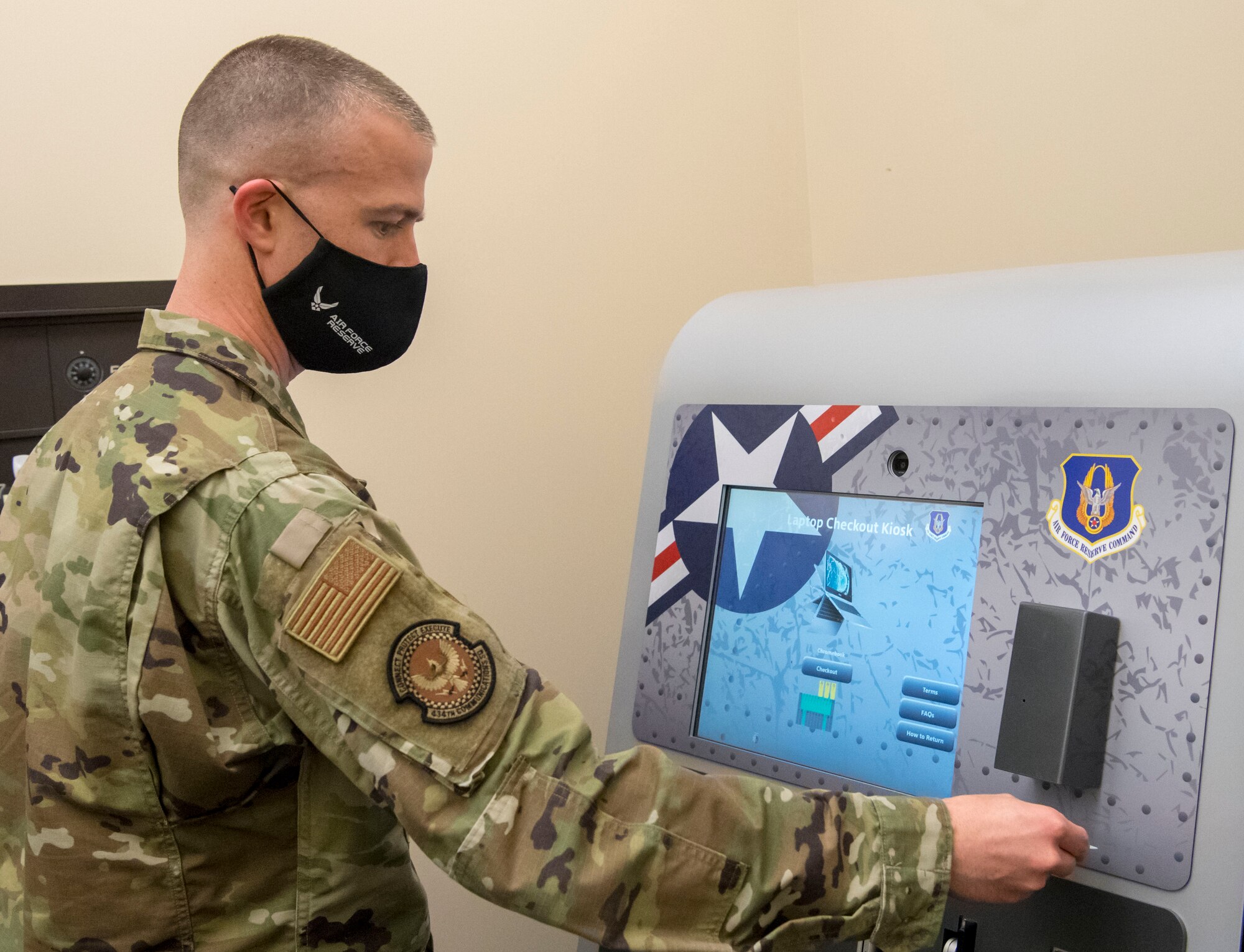 Master Sgt. Joshua Sandefur, 434th Communications Squadron client systems technician, demonstrates how to sign out a Google Chromebook from one of the many kiosks available to Grissom Airmen on March 13, 2021, Grissom Air Reserve Base, Indiana. Airmen can use the laptops to access the Air Force network safely and securely from home. (U.S. Air Force photo by Senior Airman Jonathan Stefanko)