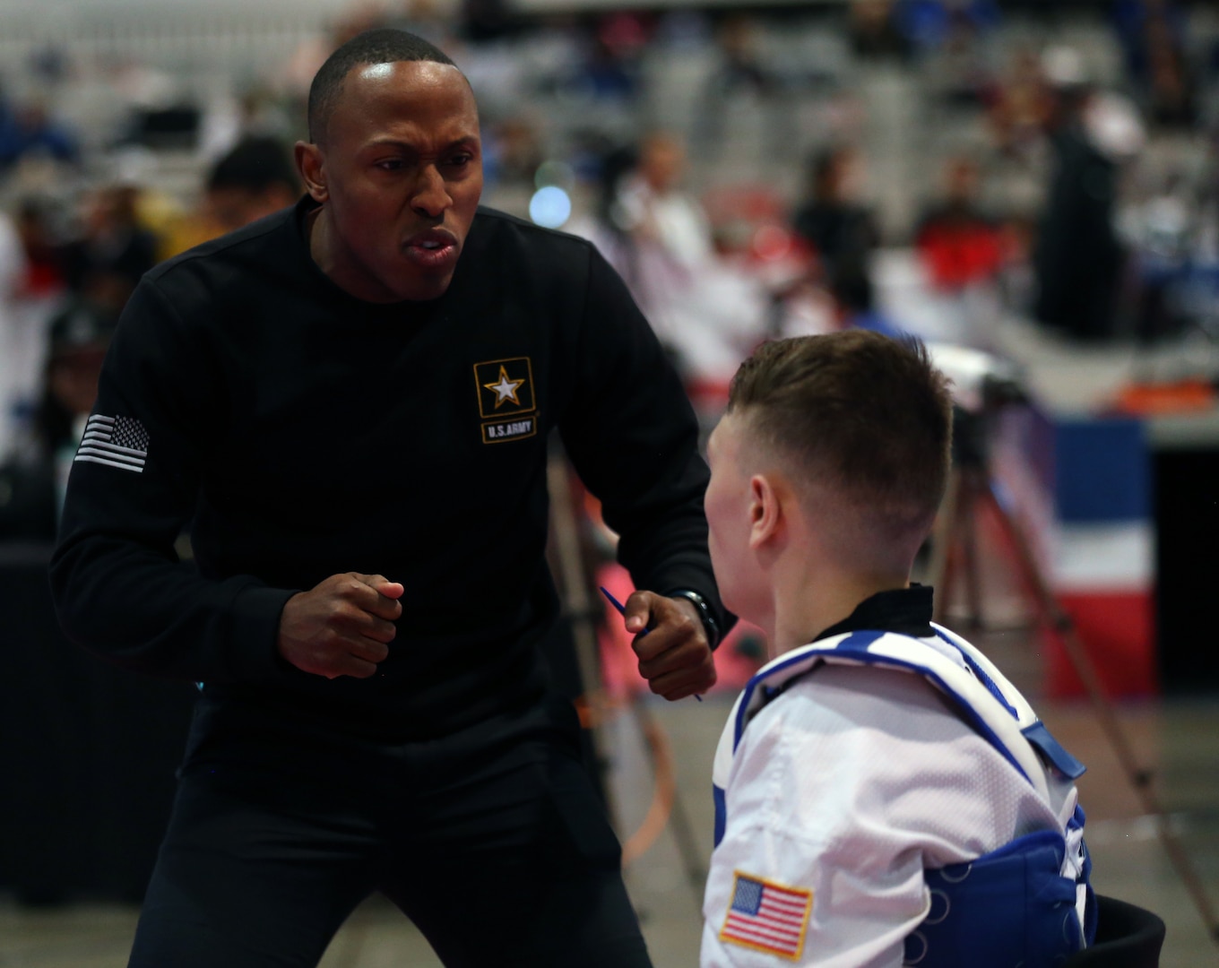 Photo of Sgt. Terrence Jennings coaching Sgt. Charles Buset.