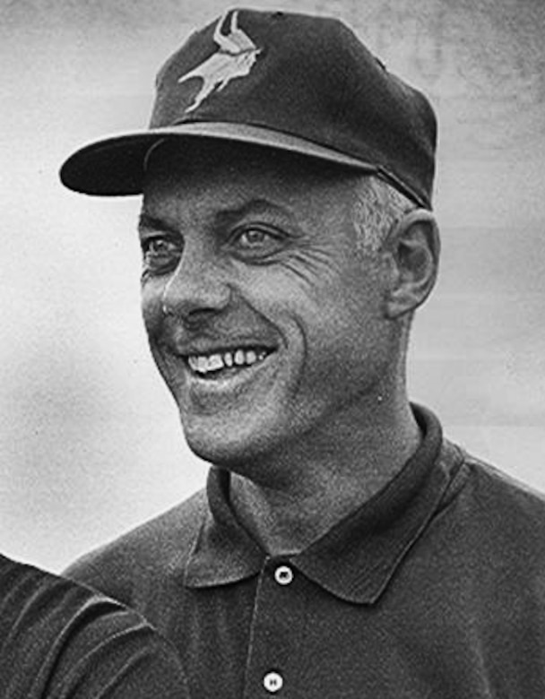 A man wearing a cap smiles.