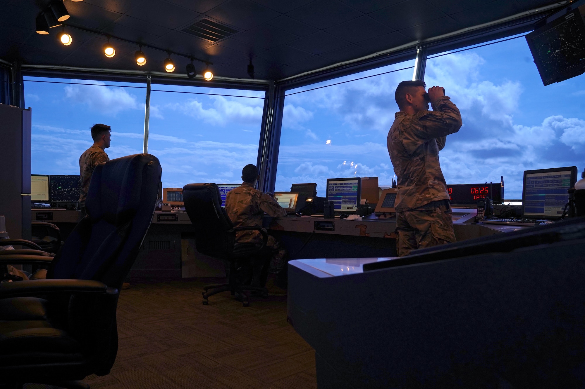 U.S. Air Force Staff Sgt. Brandon Ahuna, 81st Training Wing Operations Support Flight tower watch supervisor, Senior Airman Marcus Hamilton, 81st TRW air traffic control trainer, Airman 1st Class Jacob Penny, 81st TRW air traffic controller, work inside the Keesler Air Traffic Control tower at Keesler Air Force Base, Mississippi, June 25, 2021. The 81st TRW OSF traffics the aircraft on the Keesler flightline and the local airspace. (U.S. Air Force photo by Senior Airman Seth Haddix)