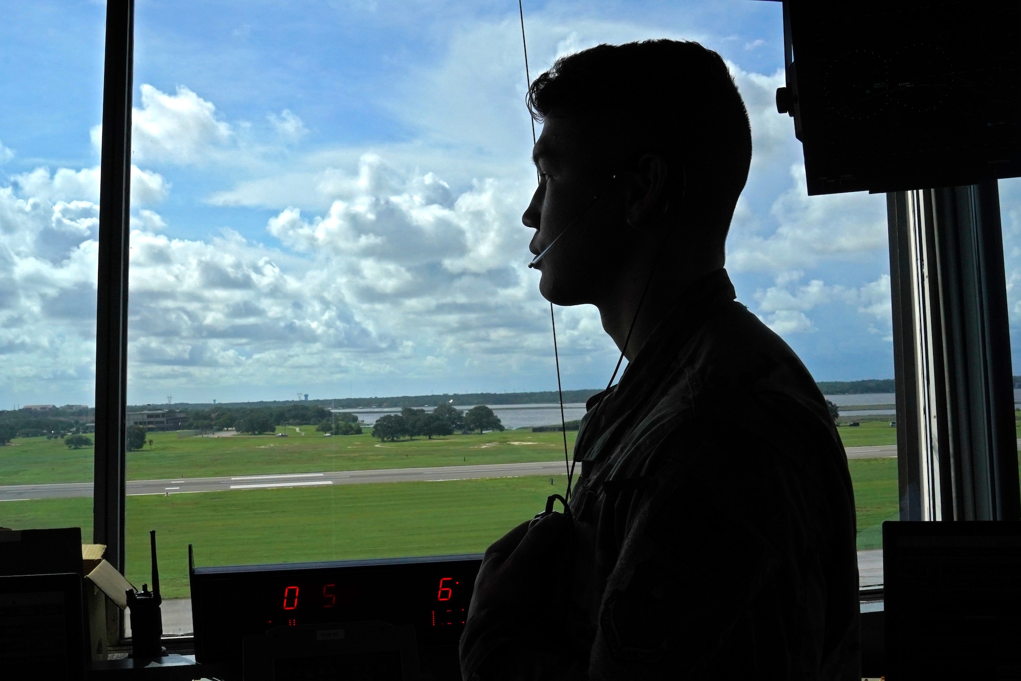 U.S. Air Force Airman 1st Class Jacob Penny, 81st Training Wing air traffic controller, poses for a photo inside the Keesler Air Traffic Control tower at Keesler Air Force Base, Mississippi, June 25, 2021. The 81st TRW Operations Support Flight traffics the aircraft on the Keesler flightline and the local airspace. (U.S. Air Force photo by Senior Airman Seth Haddix)
