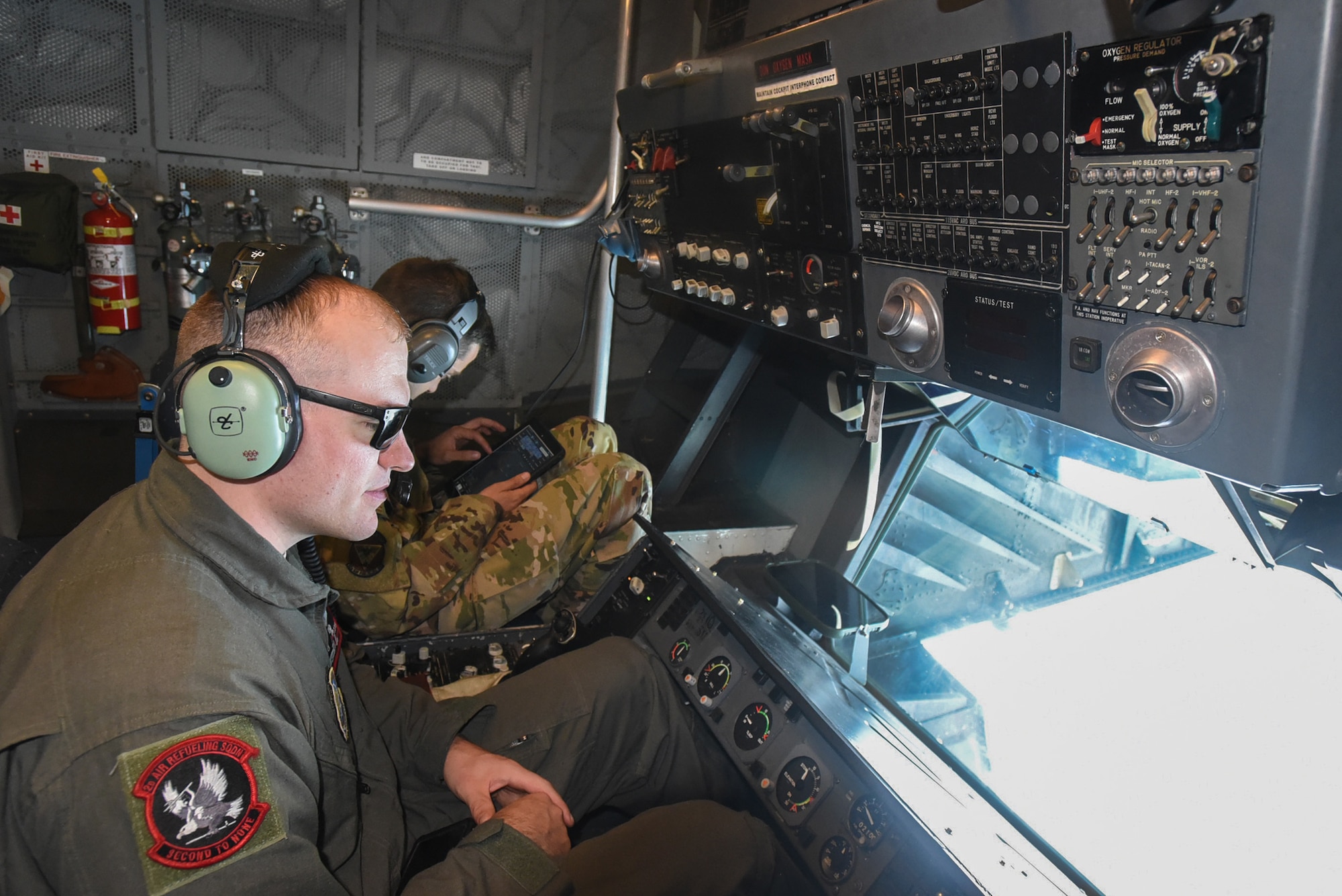 U.S. Air Force Staff Sgt. Justin Draffen, 2nd Air Refueling Squadron boom operator, and Capt. Steven Trochlil, 32nd ARS prepare to refuel a U.S. Navy Blue Angels F/A-18 Hornet from a KC-10 Extender assigned to the 305th Air Mobility Wing on Joint Base McGuire-Dix-Lakehurst, N.J., June 28, 2021. The Blue Angels needed in-flight refueling during their flight home to Florida after participating in an Air Show. (U.S. Air Force photo by Senior Airman Ariel Owings)