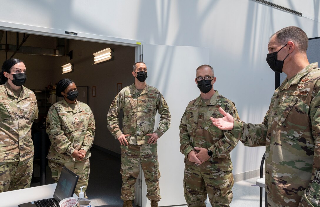 Col. Matt Husemann, right, 436th Airlift Wing commander, speaks with Airmen from the Patriot Express COVID-19 testing site at the Baltimore/Washington International Thurgood Marshall Airport in Baltimore, June 27, 2021. The facility, operated by Team Dover and other Air Mobility Command Airmen since November 2020, provides on-site, rapid COVID-19 testing for individuals traveling to overseas duty locations. (U.S. Air Force photo by Airman 1st Class Cydney Lee)