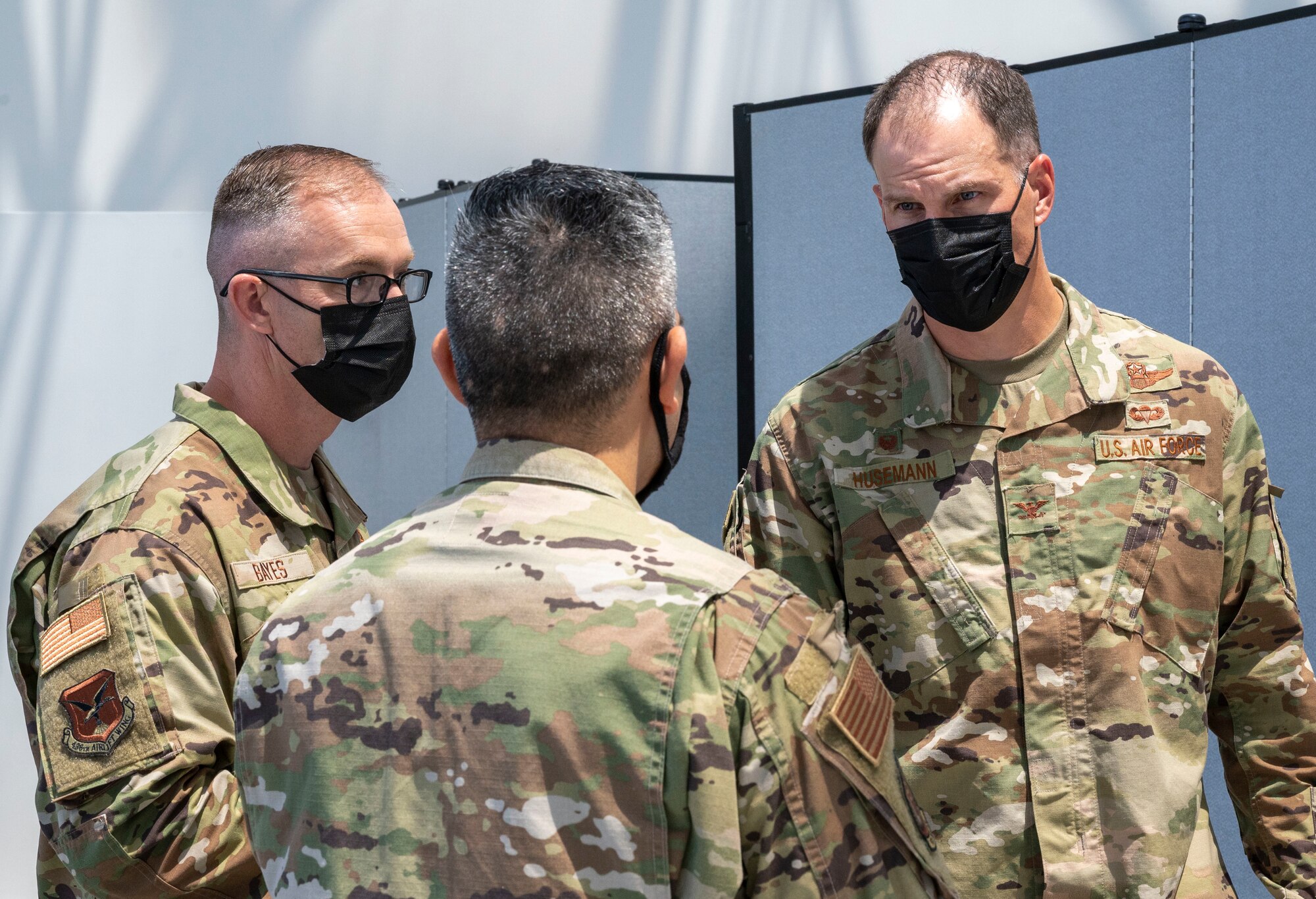 Chief Master Sgt. Timothy Bayes, left, 436th Airlift Wing command chief and Col. Matt Husemann, right, 436th AW commander, speak with Capt. Samuel Chavez, Patriot Express COVID-19 testing site officer in charge, at the Baltimore/Washington International Thurgood Marshall Airport in Baltimore, June 27, 2021. The facility, operated by Team Dover and other Air Mobility Command Airmen since November 2020, provides on-site, rapid COVID-19 testing for individuals traveling to overseas duty locations. (U.S. Air Force photo by Airman 1st Class Cydney Lee)