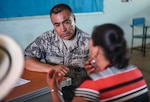 U.S. Air Force Chief Master Sergeant Mario Aceves, Medical Readiness Training Exercise chief enlisted manager, uses Spanish-language skills to speak with woman during exercise New Horizons 2018, May 14, 2018, in Coclé Province, Panama (U.S. Air Force/Dustin Mullen)