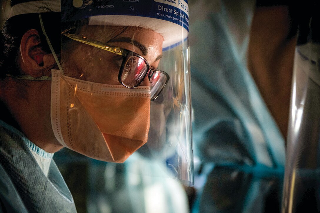 U.S. Air Force nurse assigned to 18th Operational Medical Readiness Squadron talks with other medical personnel while participating in simulated mass casualty aeromedical evacuation during exercise Cope North 21, at Northwest Field, Guam, February 10, 2021 (U.S. Air Force/Duncan C. Bevan)