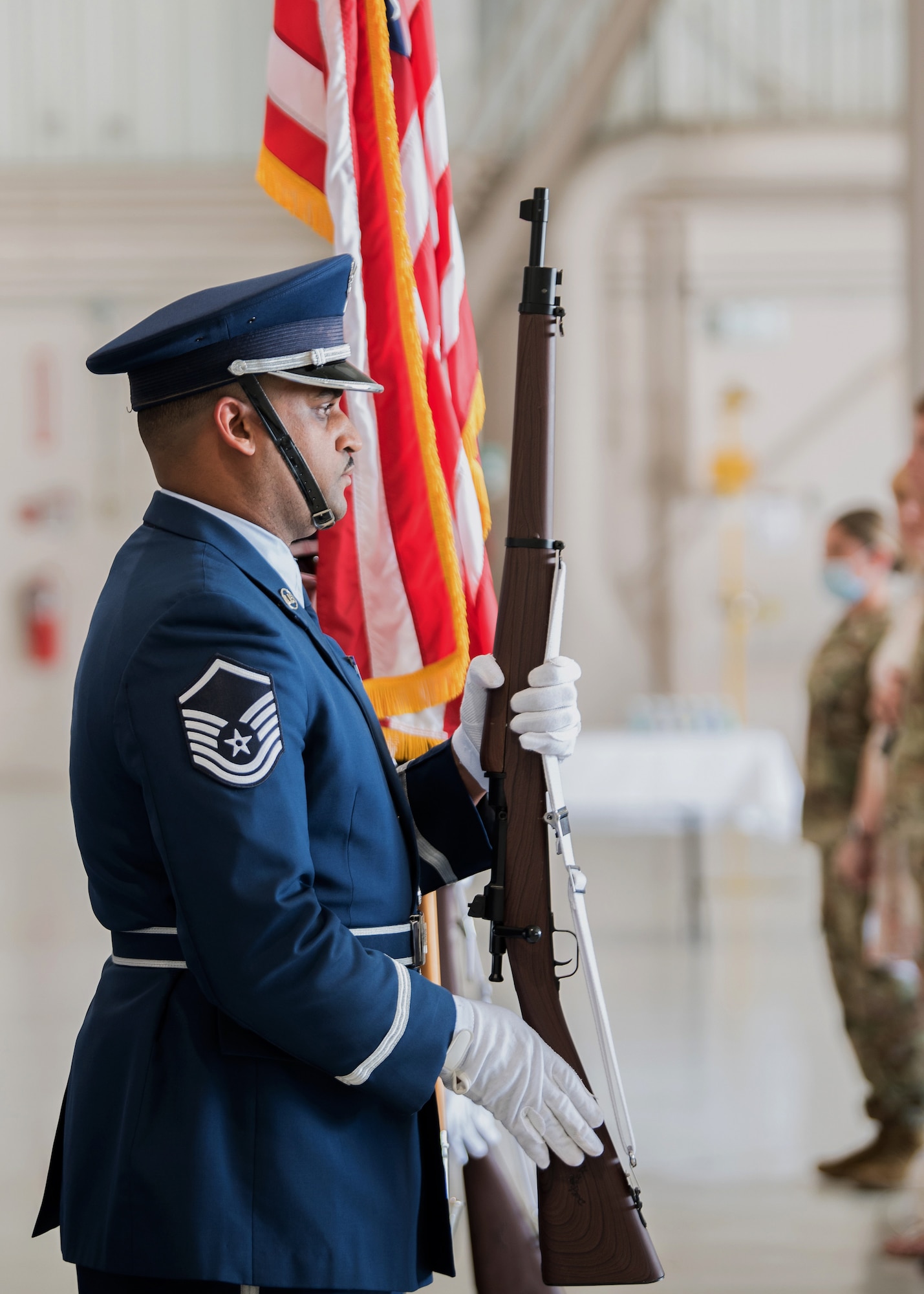 Master Sgt. Jason Newby, a member of the 123rd Airlift Wing’s Base Honor Guard, stands at attention for the playing of the National Anthem during a ceremony at the Kentucky Air National Guard Base in Louisville, Ky., May 15, 2021. Chief Master Sgt. James Tongate assumed responsibility as the newest state command chief during the ceremony. (U.S. Air National Guard photo by Senior Airman Chloe Ochs)