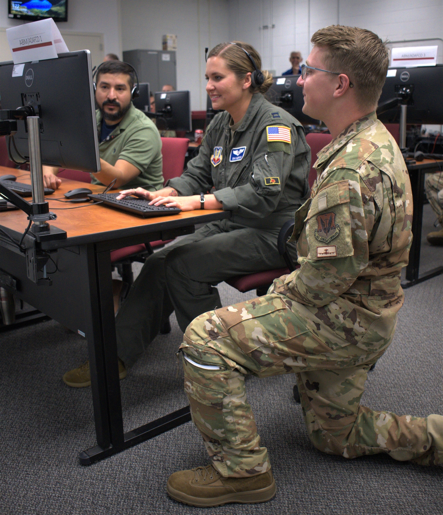 The Air Force Research Laboratory Directed Energy Directorate held a Directed Energy Utility Concept Experiment June 21 - 25 at Kirtland AFB, N.M. Capt. Scott Seidenberger, who served as an air battle manager during the DEUCE, speaks with two warfighters who participated in the experiment’s wargaming modeling and simulation scenarios. (Courtesy photo)