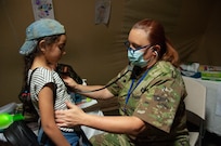 U.S. Air Force Lt. Col. Nicole Christiano, a physician with the 146th Airlift Wing, examines a pediatric patient at the Military Medical Surgical Field Hospital in Tafraoute, Morocco on June 13, 2021 during African Lion 2021.