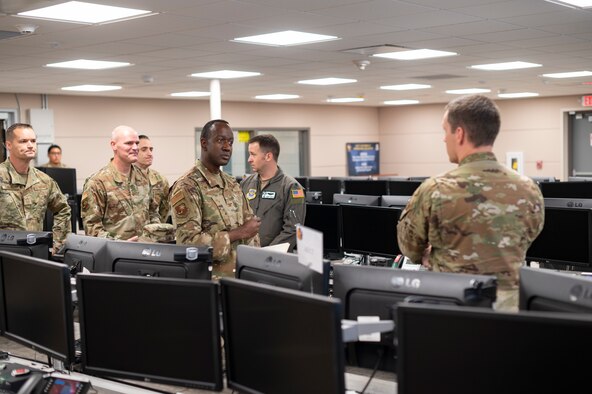 U.S. Air Force Col. Travis Edwards, center, 621st Contingency Response Wing commander, receives a unit briefing from members of the 621 st Mobility Support Operations Squadron during his East Coast immersion June 25, 2021, at Joint Base McGuire-Dix-Lakehurst, New Jersey. Edwards participated in an
immersion event, centered around a simulated contingency scenario and learned what each squadron would provide if that contingency happened. (U.S. Air Force photo by Tech. Sgt. Luther Mitchell)