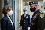 French defense minister and U.S. Army general walk.