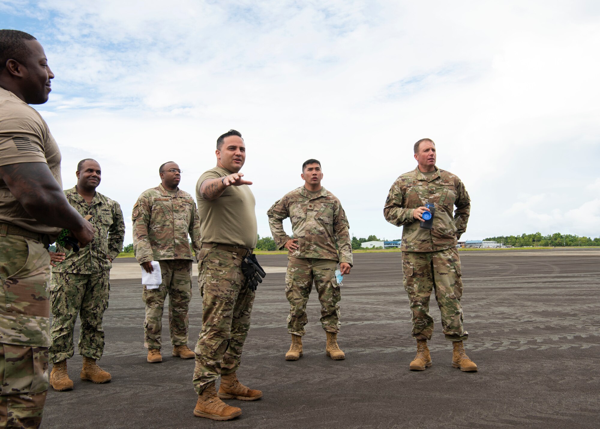 U.S. Air Force Master Sgt. Lynn Stephan, an air advisor from the 36th Contingency Response Support Squadron, briefs U.S. Air Force Col. R Schmidt, 36th Contingency Response Group commander, on the Palau National Airport, June 23, 2021. A Mobile Training Team of subject matter experts from Andersen AFB went to teach members from the Ministry of Justice and Ministry of Public Infrastructure and Institution in Palau how to properly utilize equipment they received from the Department of Defense. (U.S. Air Force photo by Senior Airman Aubree Owens)