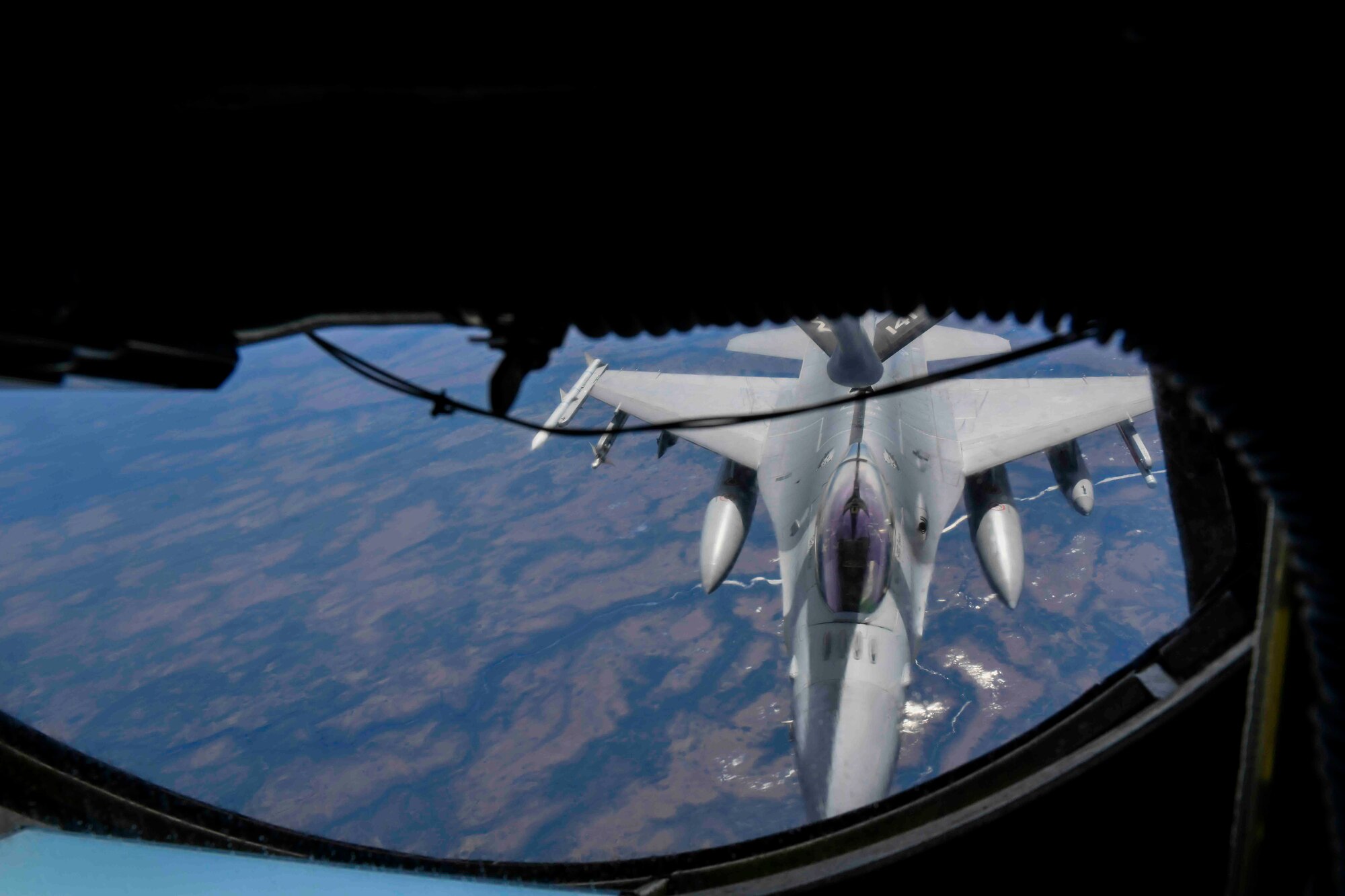 A U.S. Air Force F-16 Fighting Falcon from 120th Fighter Squadron, Colorado Air National Guard, joins up behind a KC-135 Stratotanker from the 141st Air Refueling Wing, Fairchild Air Force Base, to refuel during North American Aerospace Defense Command’s (NORAD) arctic air defense exercise, Amalgam Dart 21-01, June 12, 2021. Exercise Amalgam Dart will run from June 10-19, 2021, with operations ranging across the Arctic from the Beaufort Sea to Thule, Greenland. Amalgam Dart 21-01 provides NORAD the opportunity to hone continental defense skills as Canadian and U.S. forces operate together in the Arctic. A bi-national Canadian and American command, NORAD employs a network of space-based, aerial and ground-based sensors, air-to-air refueling tankers, and fighter aircraft, controlled by a sophisticated command and control network to deter, deny and defeat aerospace threats that originate outside or within our borders. (U.S. Air Force photo by Airman 1st Class Kiaundra Miller)