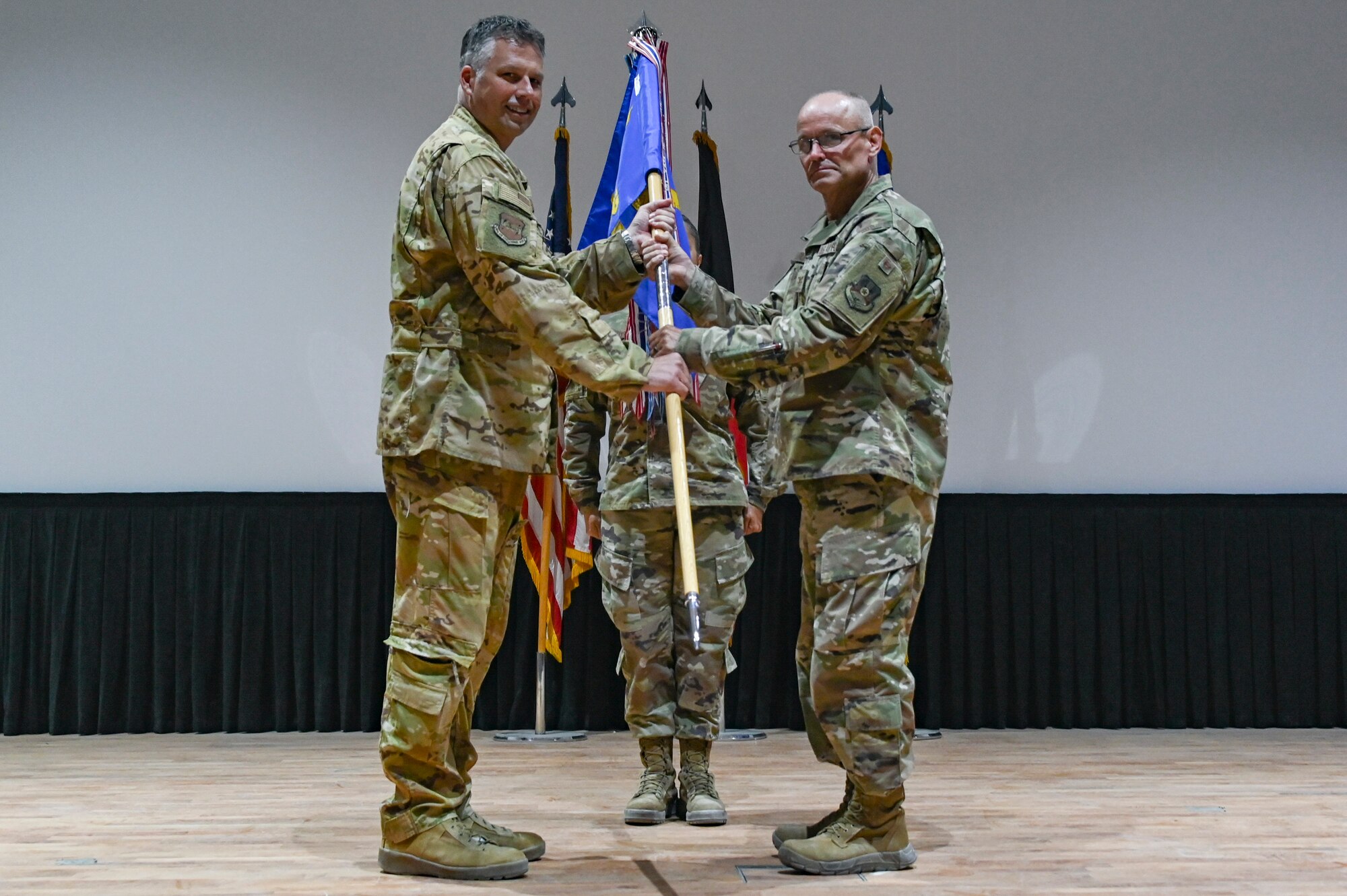 A photo of two people posing with a flag