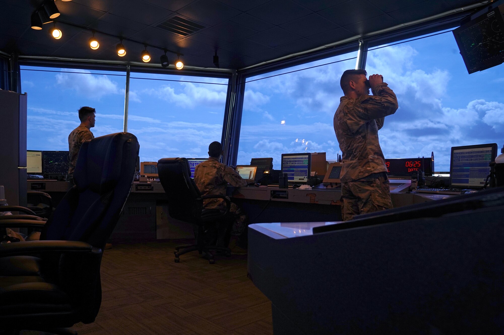 U.S. Air Force Staff Sgt. Brandon Ahuna, 81st Training Wing Operations Support Flight tower watch supervisor, Senior Airman Marcus Hamilton, 81st TRW air traffic control trainer, Airman 1st Class Jacob Penny, 81st TRW air traffic controller, work inside the Keesler Air Traffic Control tower at Keesler Air Force Base, Mississippi, June 25, 2021. The 81st TRW OSF traffics the aircraft on the Keesler flightline and the local airspace. (U.S. Air Force photo by Senior Airman Seth Haddix)