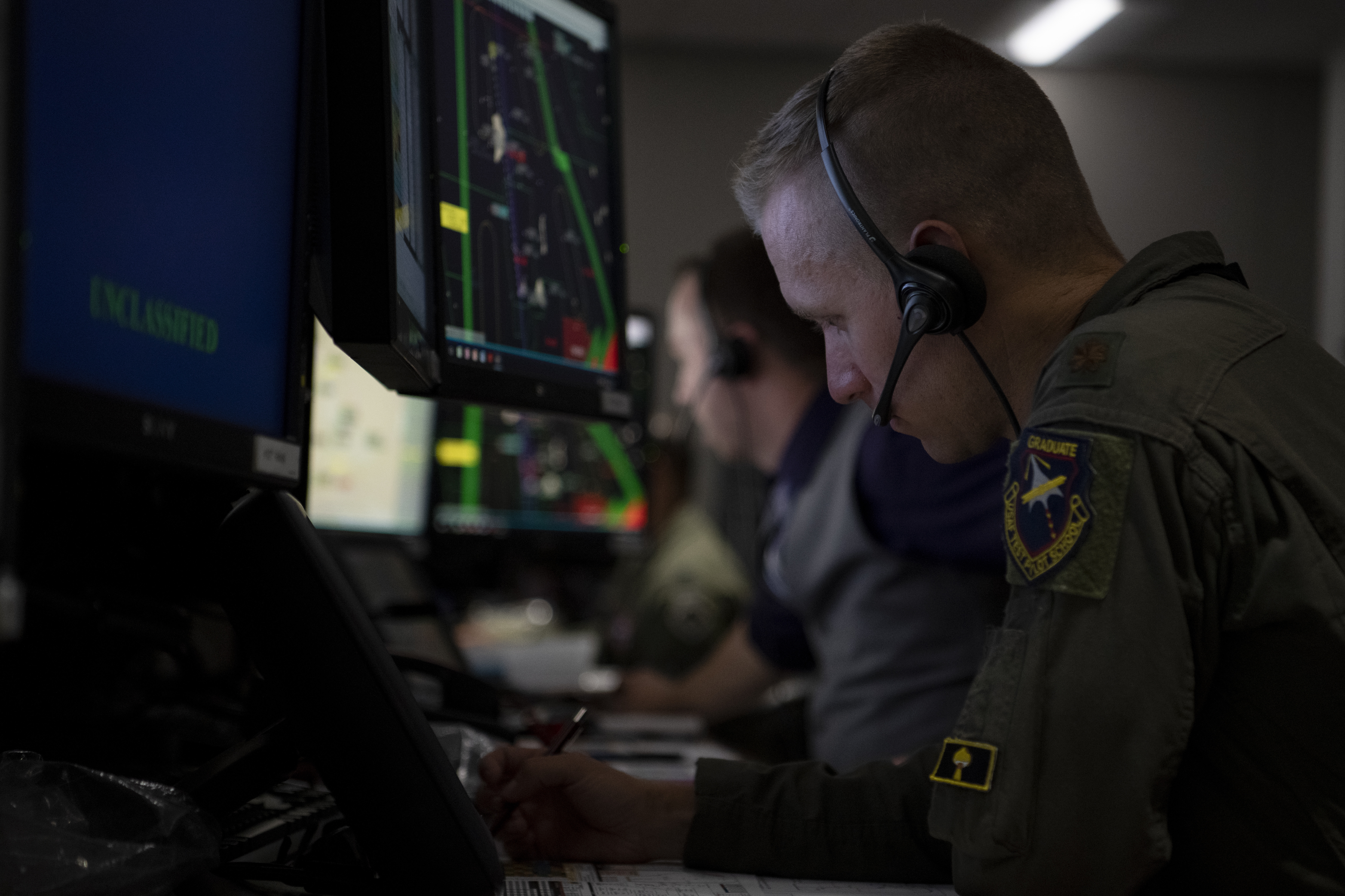 Airman works at computer in control room