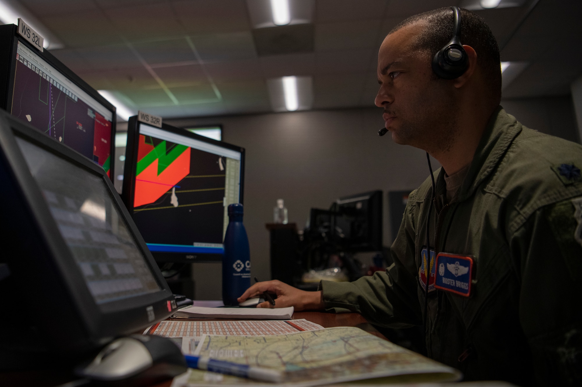 Airman works at computer in control room
