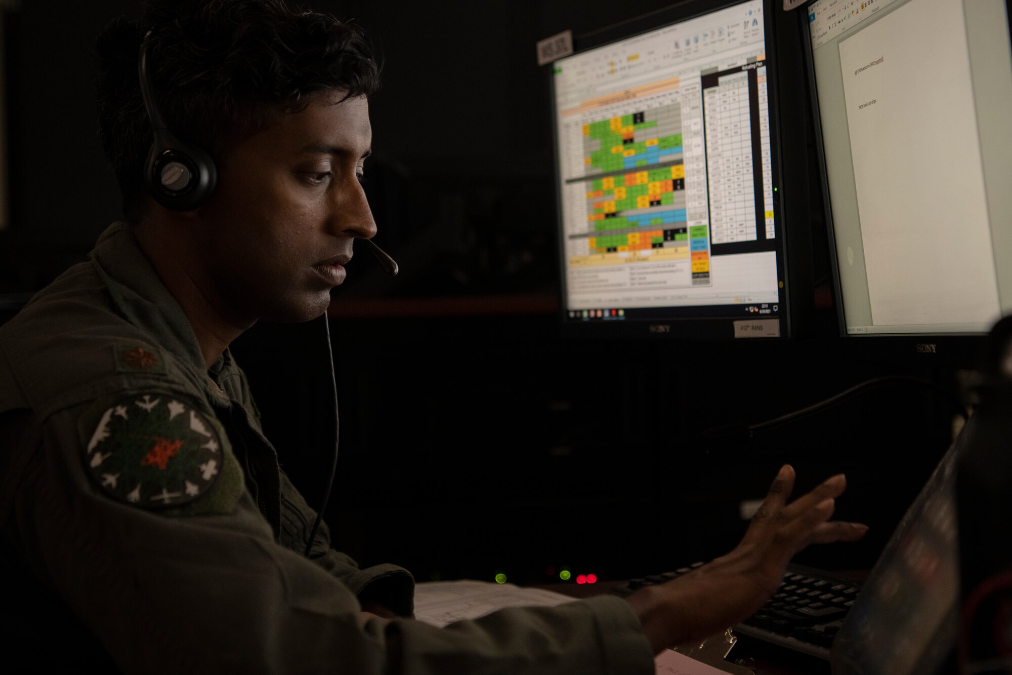 Airman works on computer in control room