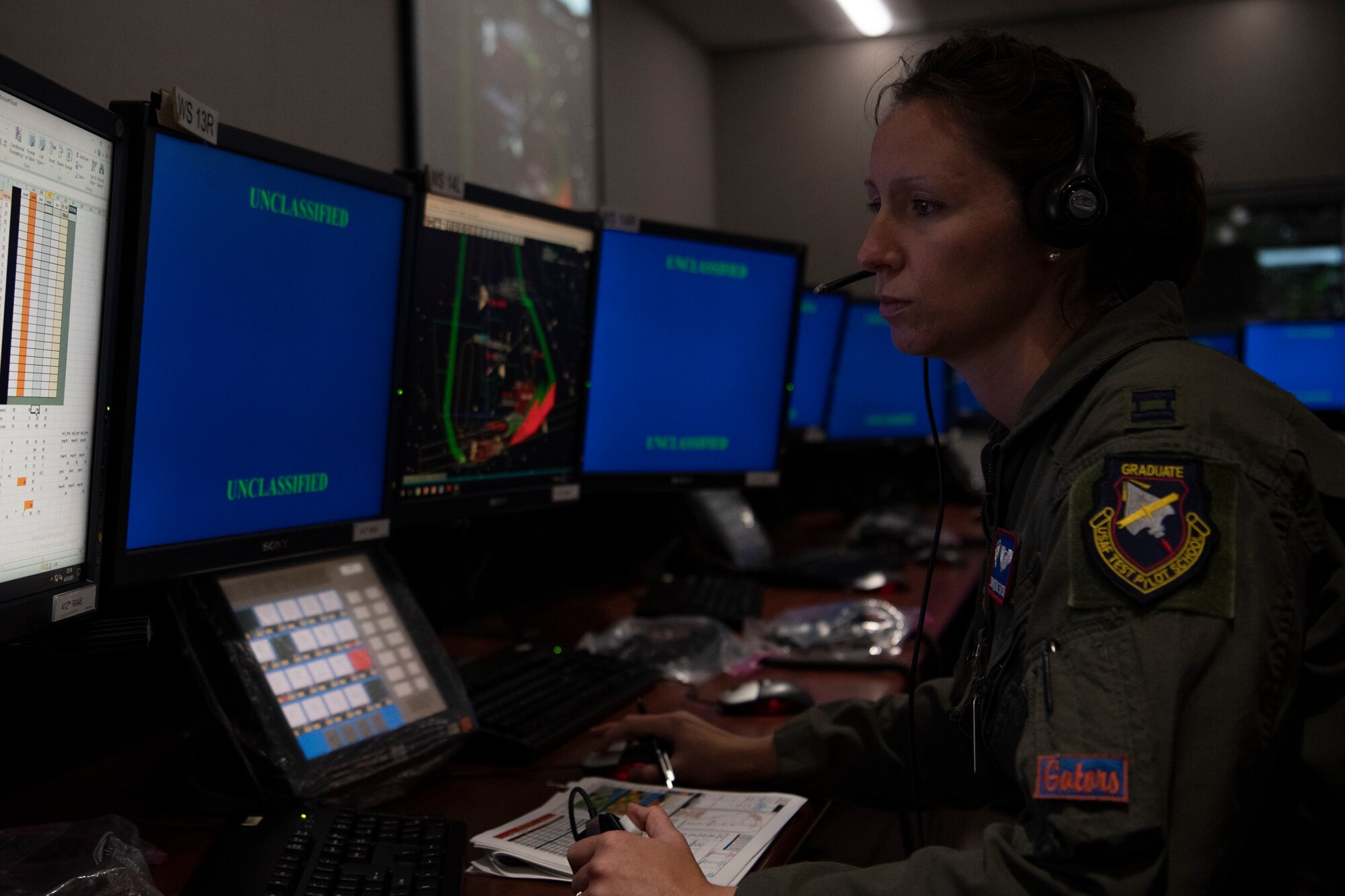 Airman works on computer in control room
