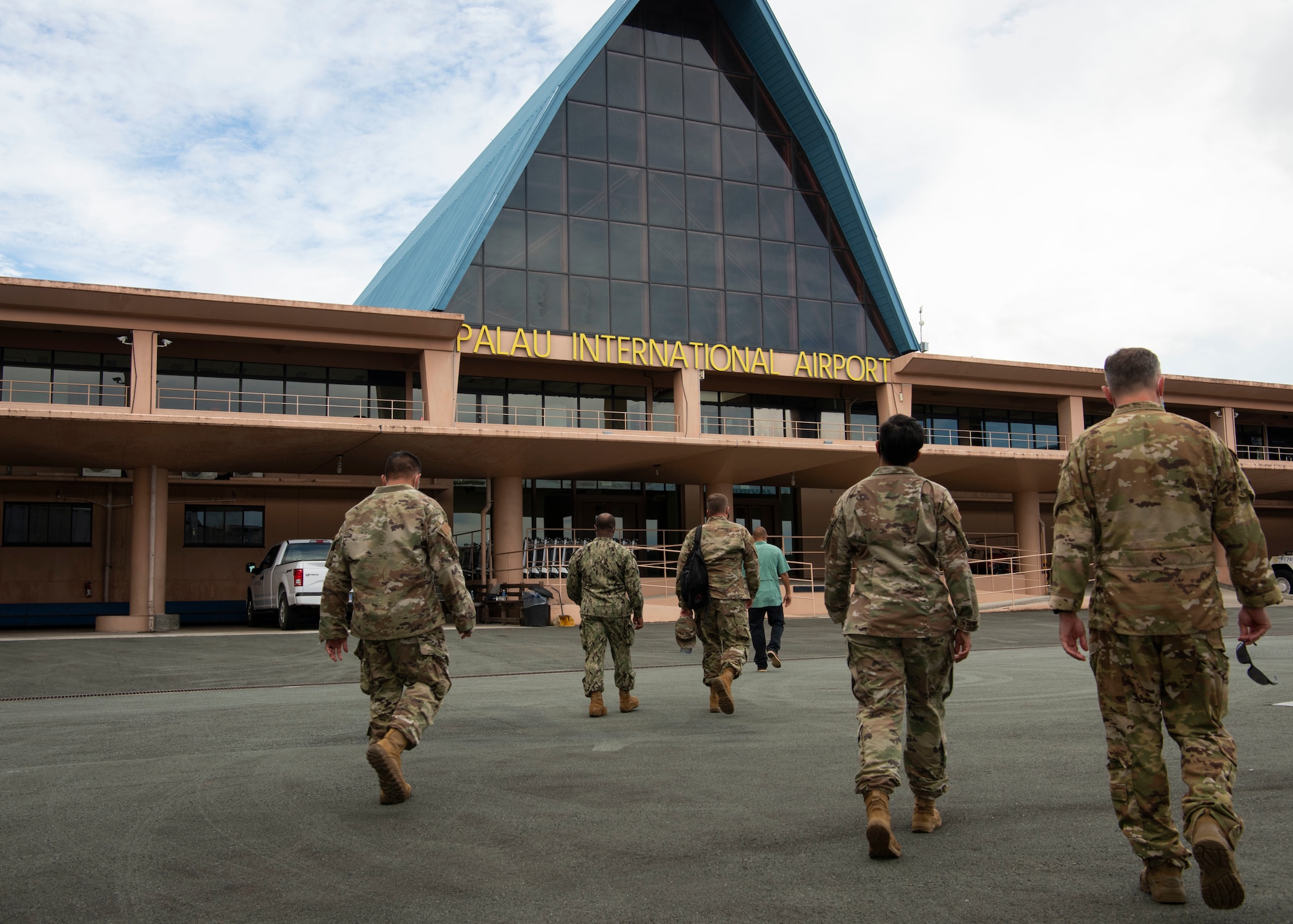 U.S. Air Force members from the 36th Contingency Response Squadron enter Palau National Airport after arriving on island for a key leader engagement, June 23, 2021. The purpose of the visit was for the commander of the 36th CRG, to meet with key leaders of Palau such as the ambassador, national security office coordinator, two governors, and to go on a walkthrough of some of the sites where his members are conducting training. (U.S. Air Force photo by Senior Airman Aubree Owens)