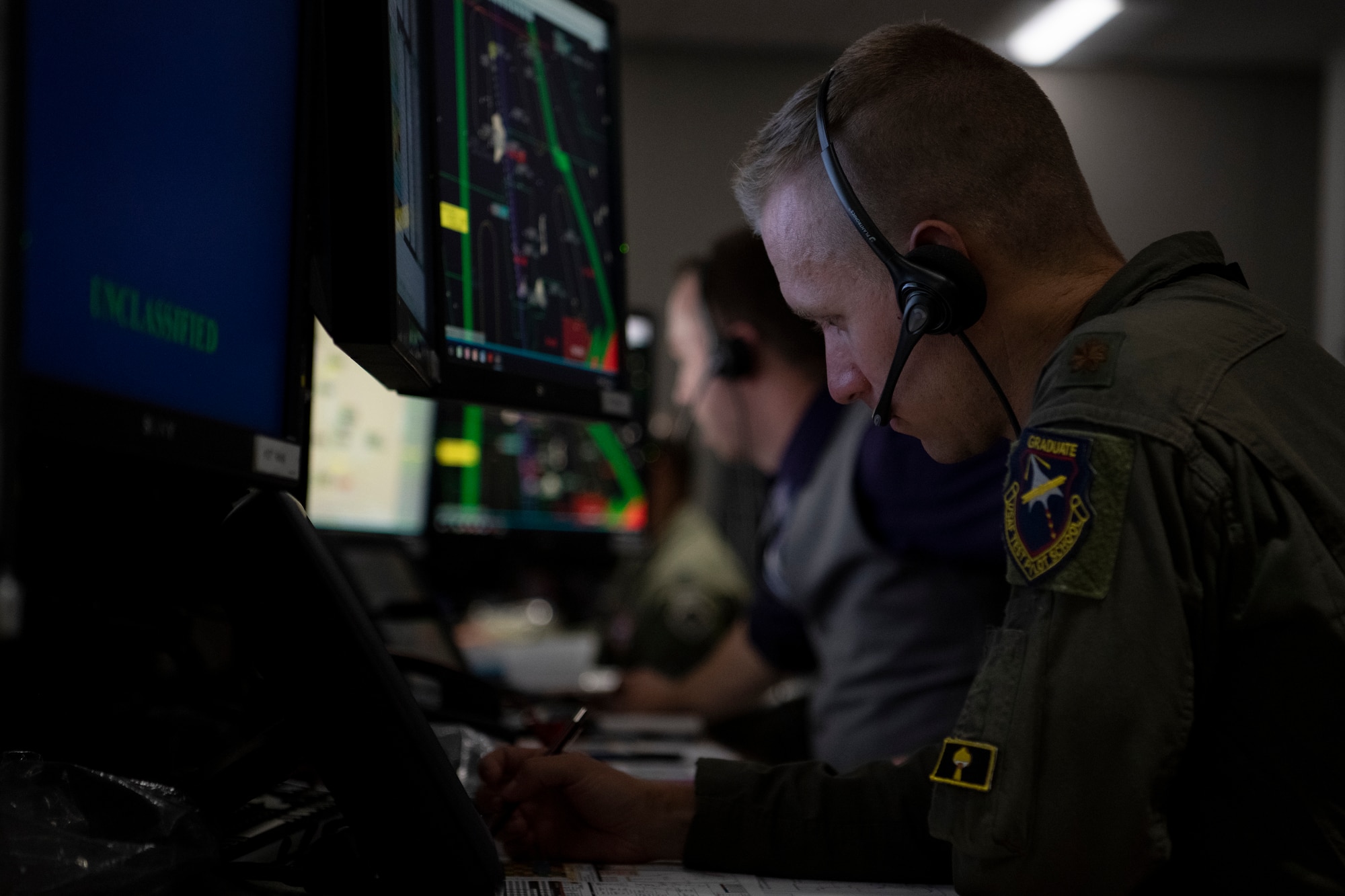 Airman works at computer in control room