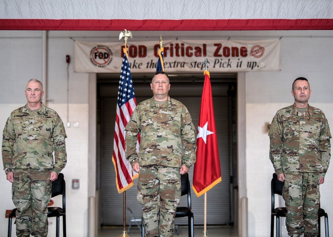 Chief Master Sgt. James Tongate (center), incoming state command chief of the Kentucky Air National Guard, stands at attention to accept his new role alongside Brig. Gen. Hal Lamberton (left), the adjutant general of Kentucky, and Chief Master Sgt. Ray Dawson (right), outgoing state command chief, during a ceremony at the Kentucky Air National Guard Base in Louisville, Ky., May 15, 2021. Tongate previously served as the 123rd Airlift Wing's human resource advisor. (U.S. Air National Guard photo by Senior Airman Chloe Ochs)