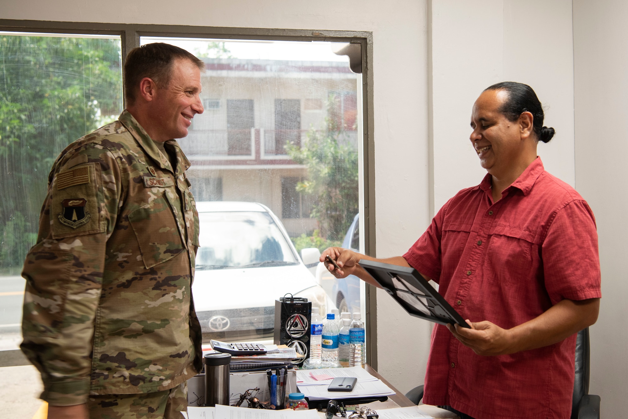 U.S. Air Force Col. R Schmidt, 36th Contingency Response Group commander, presents a signed photo and a commander’s coin to Kennosuke Suzuky, governor of Anguar, Palau during a key leader engagement in Palau, June 23, 2021. The purpose of the visit was for the commander of the 36th CRG, to meet with key leaders of Palau such as the ambassador, national security office coordinator, two governors, and to go on a walkthrough of some of the sites where his members are conducting training. (U.S. Air Force photo by Senior Airman Aubree Owens)