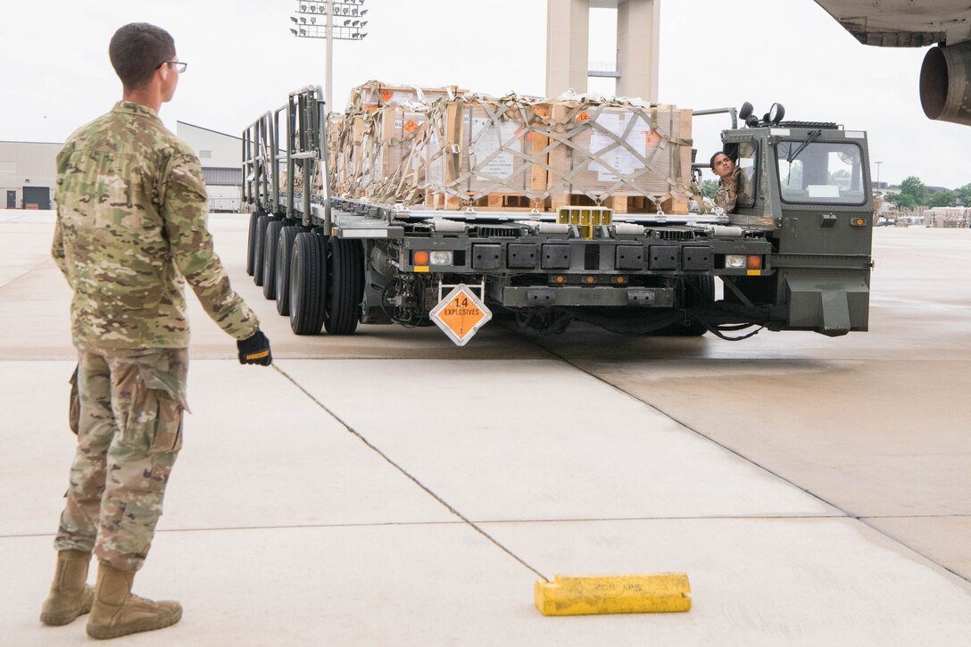Staff Sgt. Manuel Espino, 436th Aerial Port Squadron ramp services supervisor, positions a K-loader next to an aircraft bound for Ukraine at Dover Air Force Base, Delaware, June 22, 2021. Team Dover Airmen loaded pallets of materiel as part of a security assistance mission to Ukraine. Missions like this demonstrate the U.S. commitment to Ukraine’s independence, sovereignty and territorial integrity. (U.S. Air Force photo by Mauricio Campino)