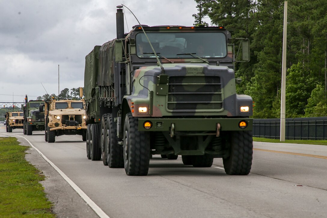U.S. Marines drive onto Camp Lejeune, North Carolina, June 3, 2021. Marines with 2nd Transportation Battalion, Combat Logistics Regiment 2, 2nd Marine Logistics Group conducted a convoy across the United States starting in Camp Lejeune, North Carolina, in one of the longest convoys in recent Marine Corps history. Marines on the convoy experimented with long-range communications, as far away as Marine Corps Air Ground Combat Center Twentynine Palms, California, the half-way point on the route. (U.S. Marine Corps photo by Cpl. Christian M. Garcia)