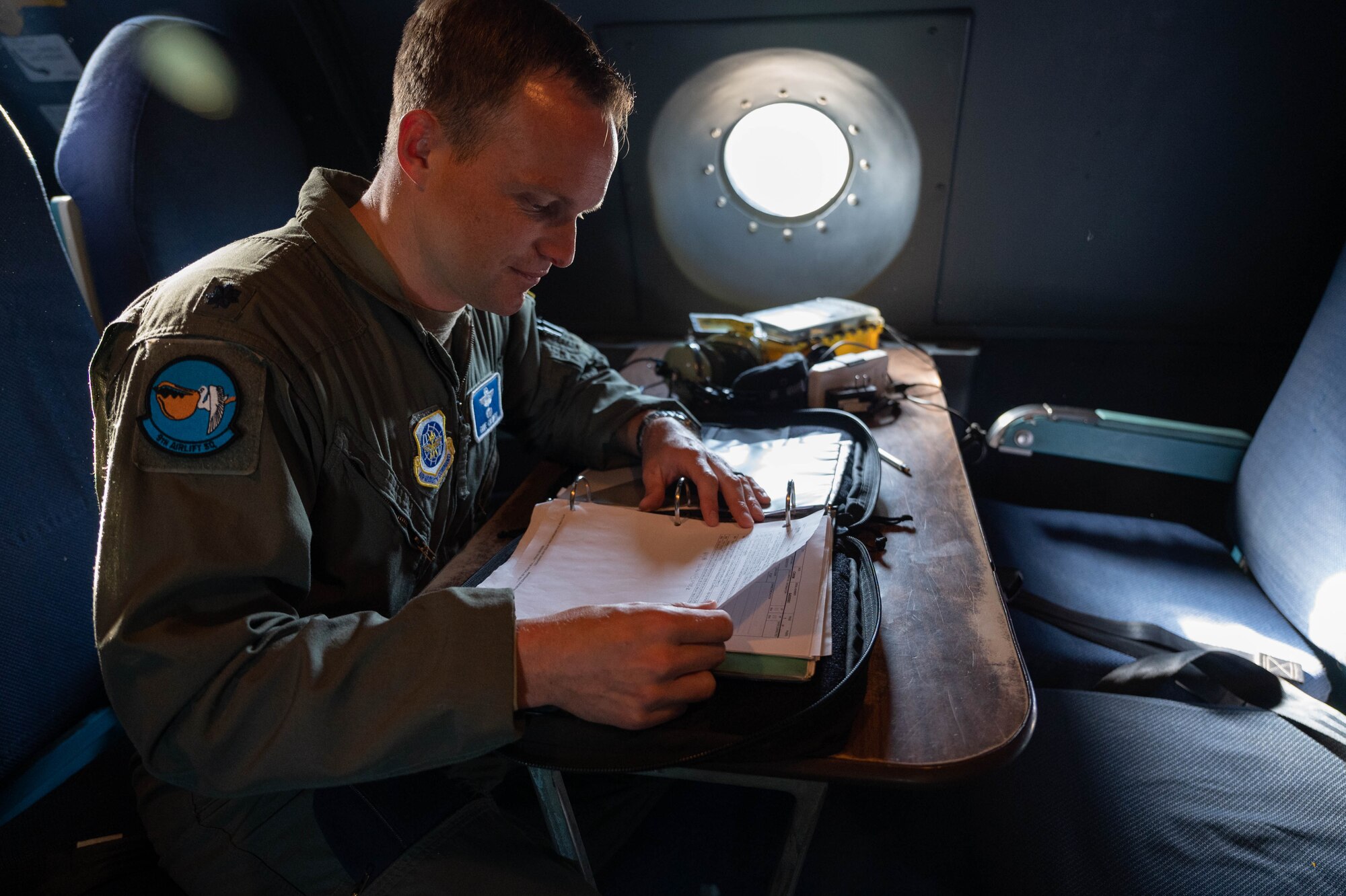 Lt. Col. David Caswell, 9th Airlift Squadron pilot, reviews maintenance records before a local training mission aboard a C-5M Super Galaxy at Dover Air Force Base, Delaware, June 23, 2021. The 9th AS routinely trains to provide global reach with unique outsized and oversized airlift capabilities on the C-5. (U.S. Air Force photo by Senior Airman Faith Schaefer)