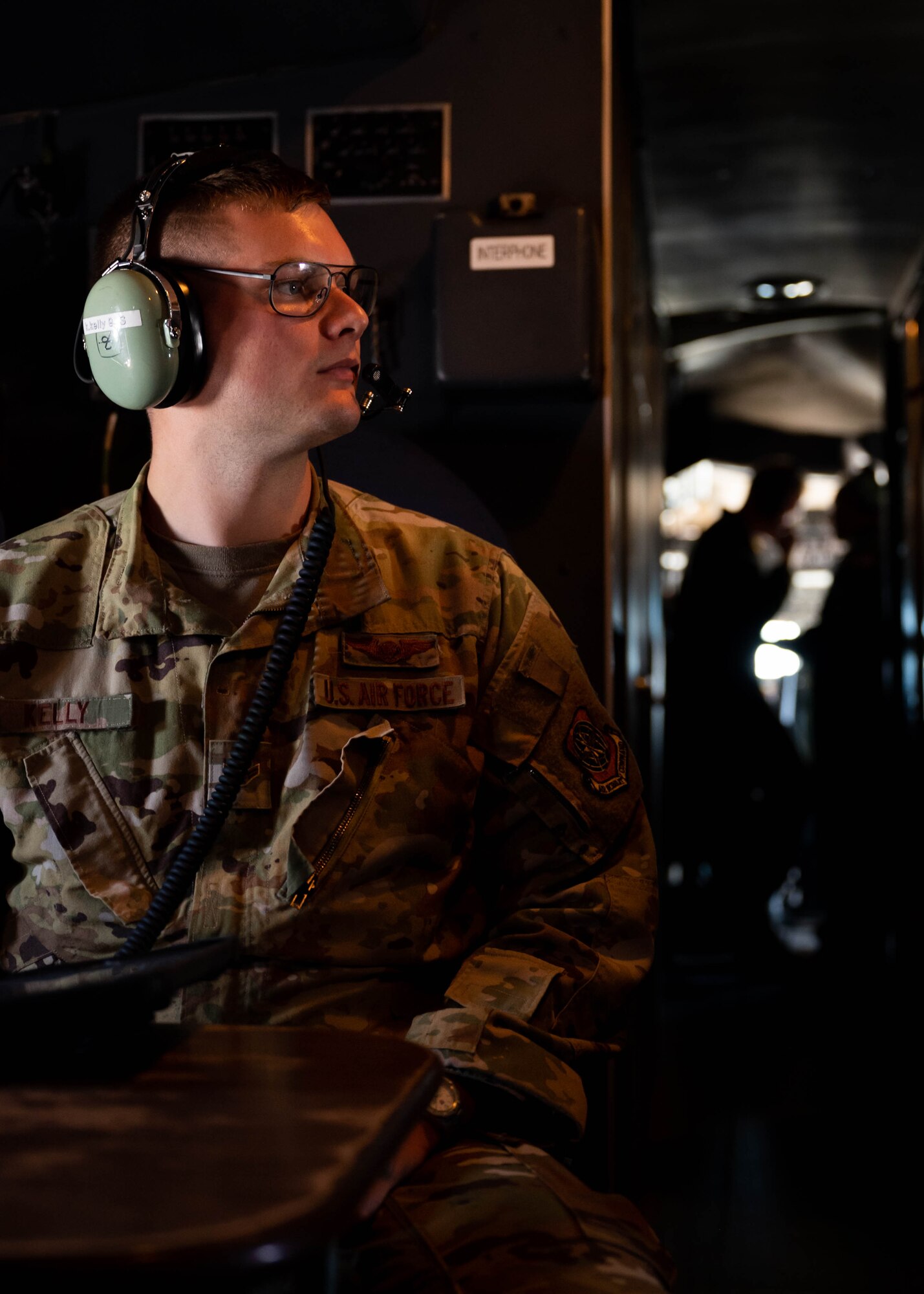 Airman 1st Class Kristopher Kelly, 9th Airlift Squadron loadmaster, sits at the working table aboard a C-5M Super Galaxy during a local training flight over New York, June 23, 2021. The 9th AS routinely trains to provide global reach with unique outsized and oversized airlift capabilities on the C-5. (U.S. Air Force photo by Senior Airman Faith Schaefer)