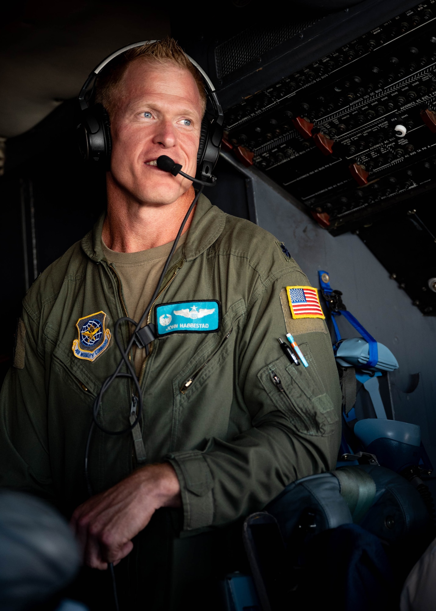 Lt. Col. John Habbestad, 9th Airlift Squadron commander, observes  the flight deck of a C-5M Super Galaxy while on a training mission over New York, June 23, 2021. This flight commemorated Habbestad’s final flight as the 9th AS commander. The 9th AS routinely trains to provide global reach with unique outsized and oversized airlift capabilities on the C-5. (U.S. Air Force photo by Senior Airman Faith Schaefer)