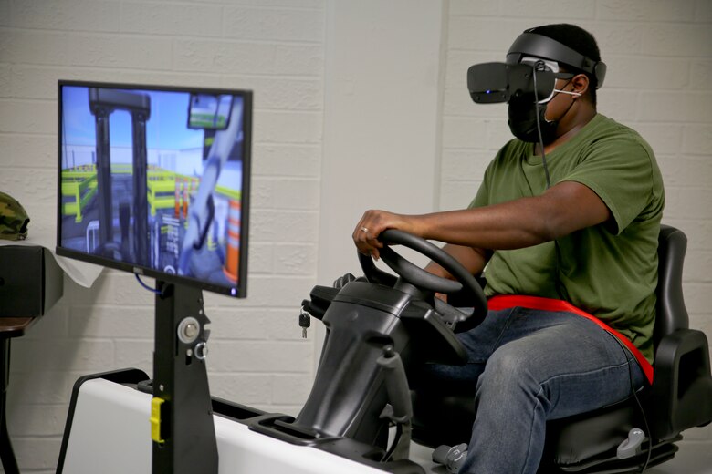 A new forklift simulator, complete with virtual reality goggles and a two-sided screen, allows for those in forklift training aboard Marine Corps Logistics Base Albany to see what they would see – and perform the same maneuvers – as if they were on a real forklift. Now in a dedicated space in the base’s Garrison Mobile Equipment branch, it provides a way to train forklift drivers with an added layer of safety. The ribbon was cut on the investment June 25. (U.S. Marine Corps photos by Jennifer Parks)
