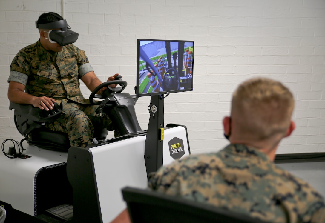 A new forklift simulator, complete with virtual reality goggles and a two-sided screen, allows for those in forklift training aboard Marine Corps Logistics Base Albany to see what they would see – and perform the same maneuvers – as if they were on a real forklift. Now in a dedicated space in the base’s Garrison Mobile Equipment branch, it provides a way to train forklift drivers with an added layer of safety. The ribbon was cut on the investment June 25. (U.S. Marine Corps photos by Jennifer Parks)