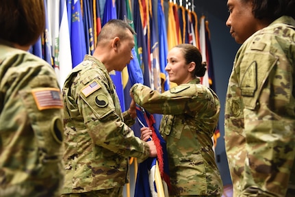 Lt. Col. Alyssa Astphan takes command of the Virginia National Guard’s Recruiting and Retention Battalion from Lt. Col. Jennifer Martin in a change of command ceremony held Dec. 7, 2018, at Fort Pickett, Virginia. Brig. Gen. Lapthe Flora, Virginia National Guard Assistant Adjutant General - Army, presided over the exchange of the guidon that represented the transfer of command from Martin to Astphan. (U.S. Army National Guard photo by Sgt. 1st Class Terra C. Gatti)