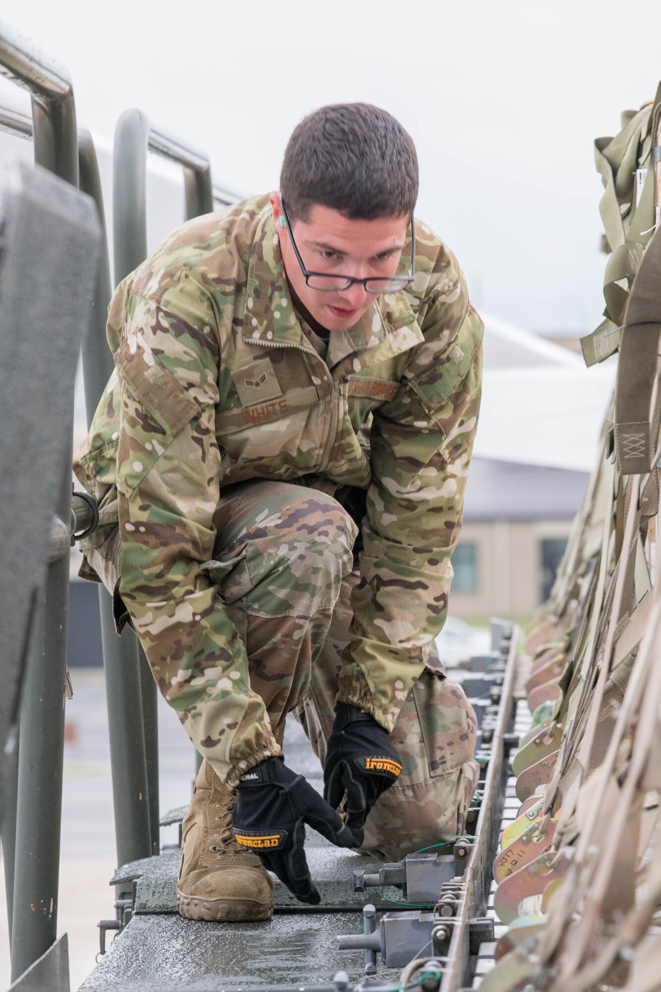 Senior Airman Thomas White, 436th Aerial Port Squadron ramp services journeyman, inspects pallets of ammunition bound for Tajikistan as part of a security assistance mission at Dover Air Force Base, Delaware, June 22, 2021. Security cooperation between the U.S. and Tajikistan advances shared security interests and supports regional stability in Central Asia. (U.S. Air Force photo by Mauricio Campino)