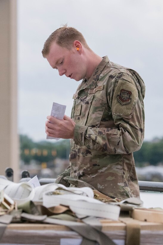 Airman 1st Class Stephen Knotts, 436th Aerial Port Squadron ramp services journeyman, reviews shipping documentation for cargo pallets bound for Tajikistan as part of a security assistance mission at Dover Air Force Base, Delaware, June 22, 2021. Security cooperation between the U.S. and Tajikistan advances shared security interests and supports regional stability in Central Asia. (U.S. Air Force photo by Mauricio Campino)